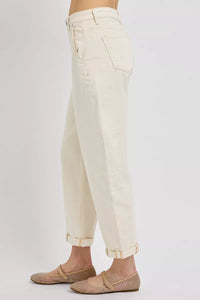 Beige pants worn by a person on a white background