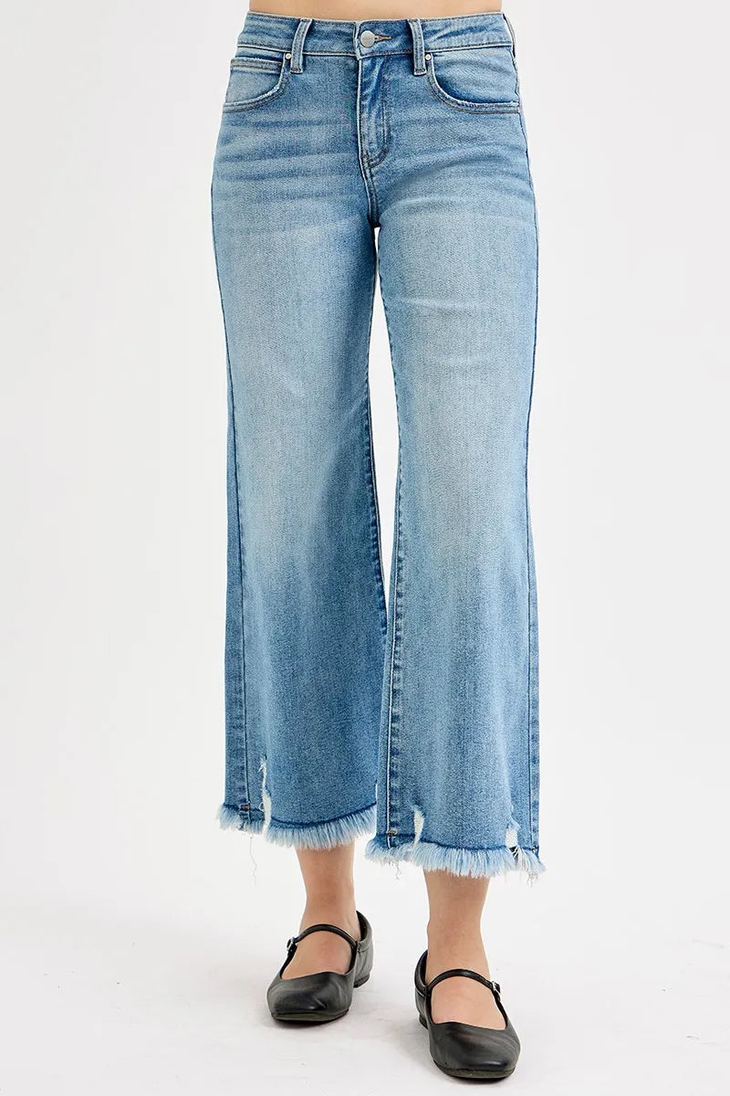 Light blue jeans with frayed hems on a white background