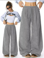 Gray wide-leg pants worn by a person on a white background