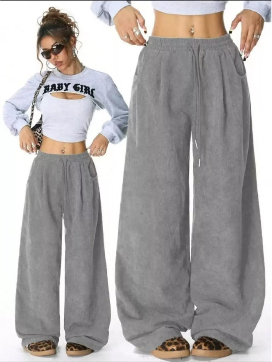 Gray wide-leg pants worn by a person on a white background