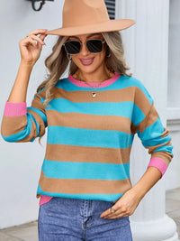 Woman wearing a colorful striped sweater and hat indoors