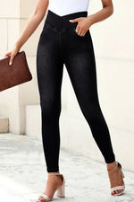 Person wearing black leggings with a white background