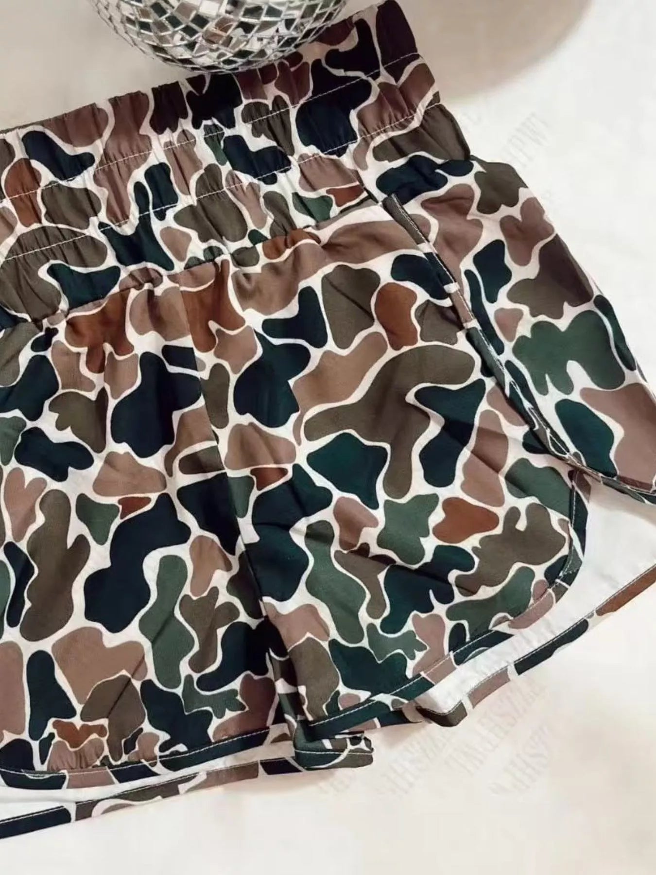 Camouflage-patterned shorts on a light background