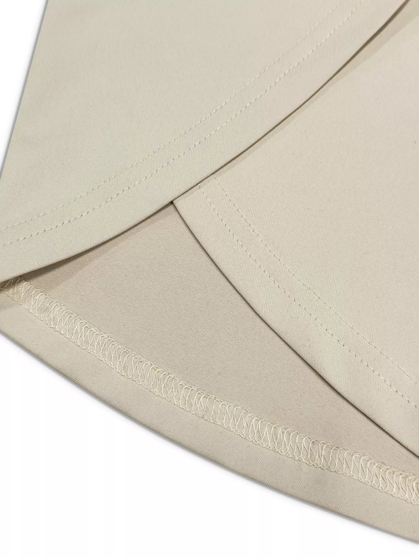 Close-up of a beige envelope with a decorative ribbon.