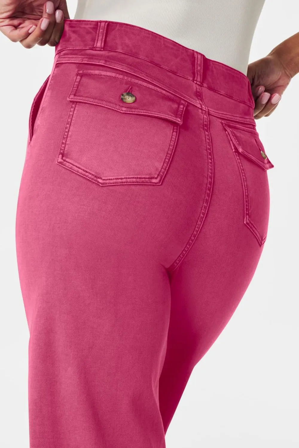 Close-up of bright pink pants with a white background