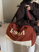 Person holding a brown drawstring bag with 'Dior' branding.