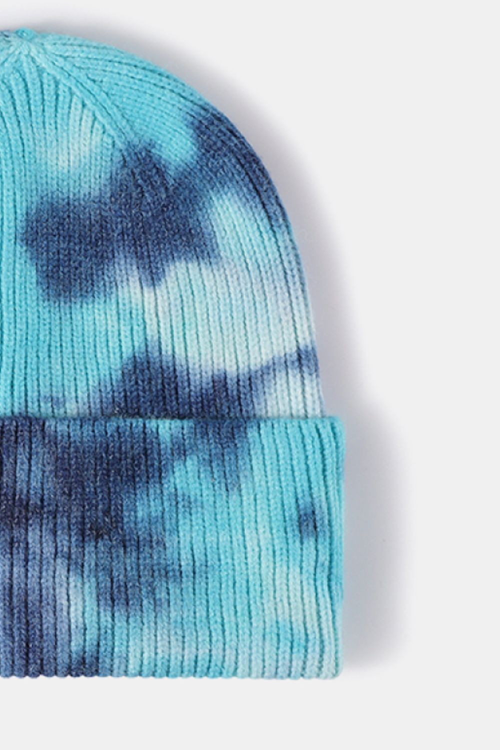 Blue and white tie-dye beanie on a white background