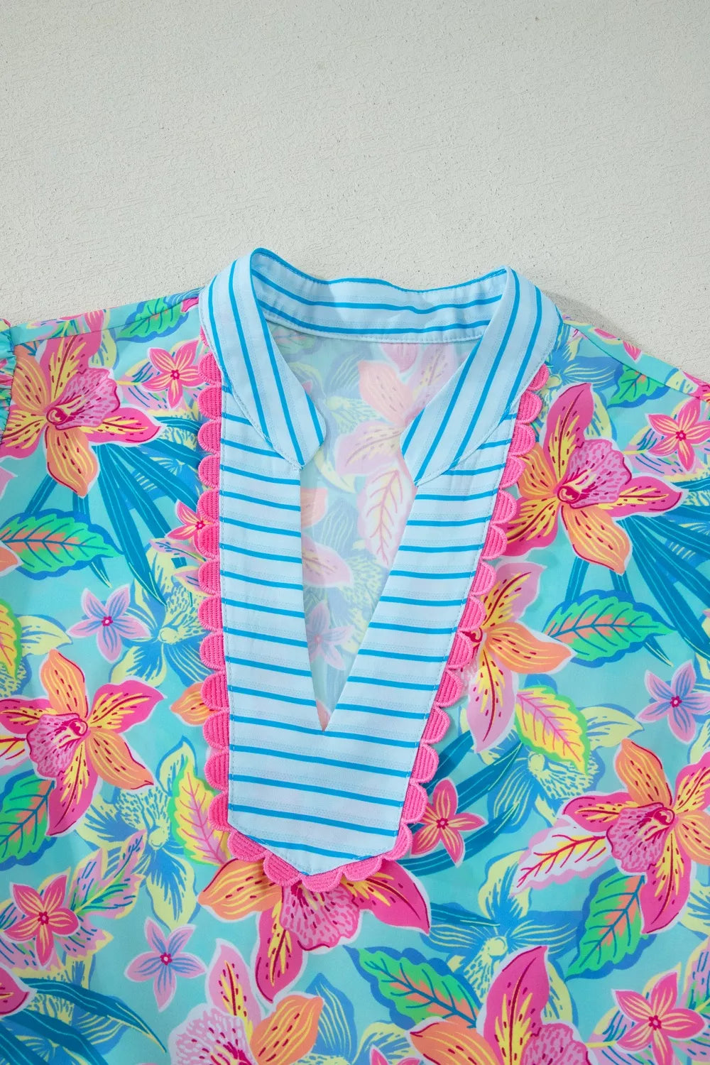 Colorful floral and striped garment on a light gray background