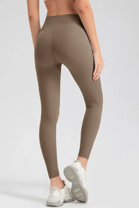 Brown leggings worn by a person on a white background