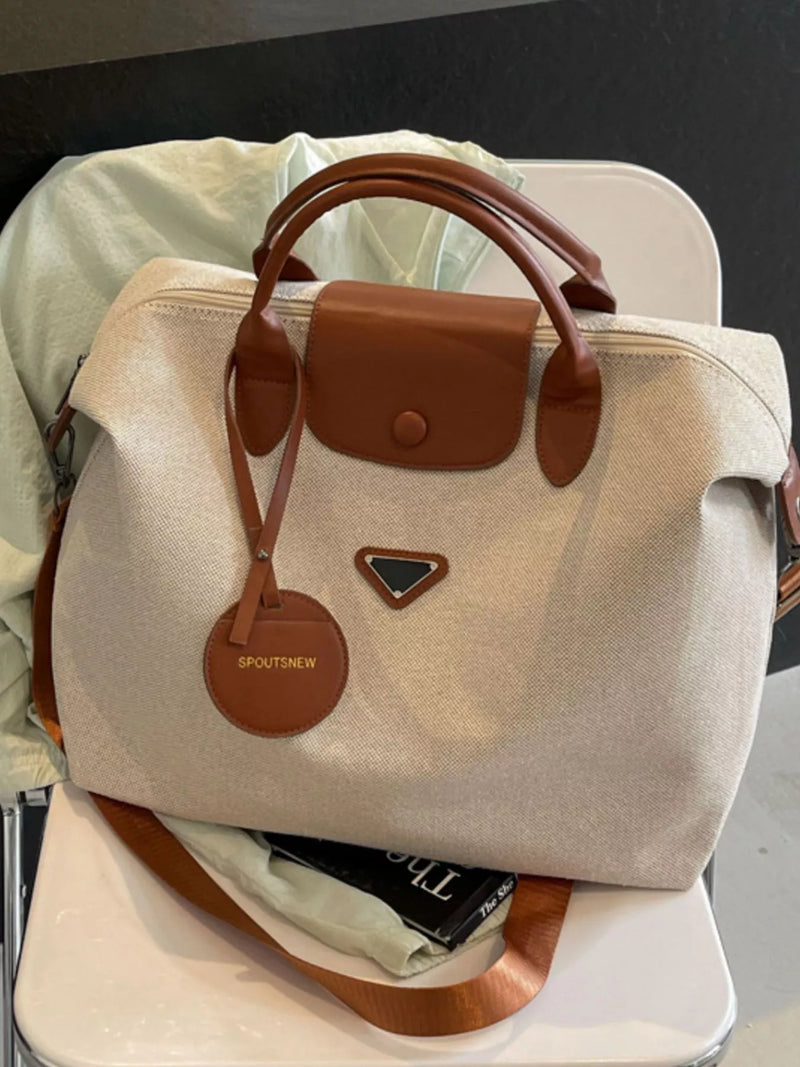 Beige handbag with brown accents on a chair