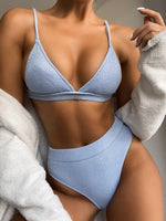 Person wearing a light blue bikini set with a neutral background