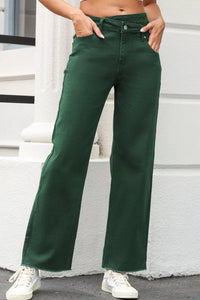 Person wearing green pants standing on a white step.