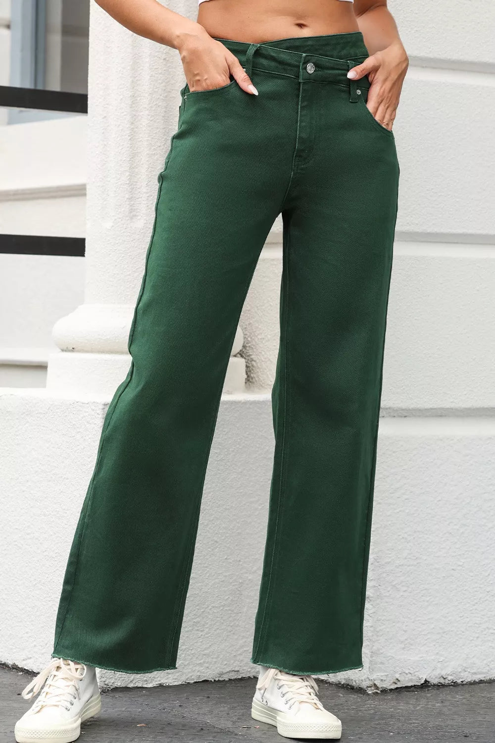 Person wearing green pants standing on a white step.