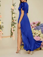 Woman wearing a blue dress with a floral background