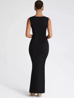 Black sleeveless dress worn by a model on a white background