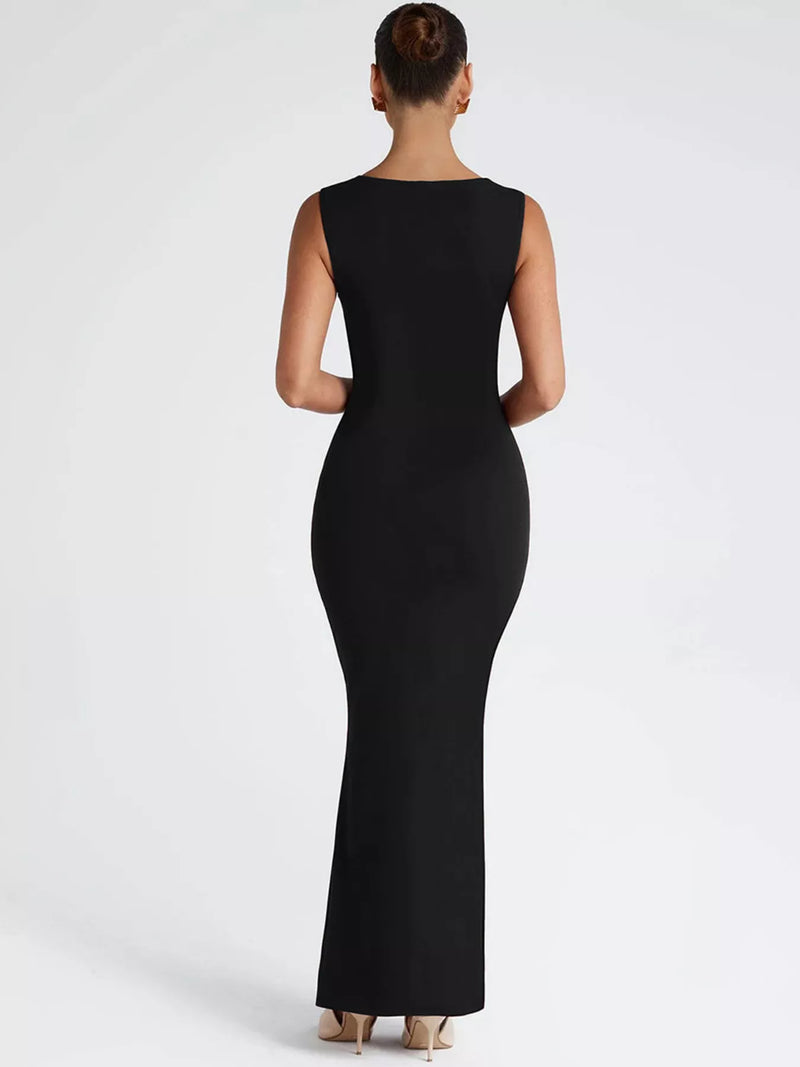 Black sleeveless dress worn by a model on a white background