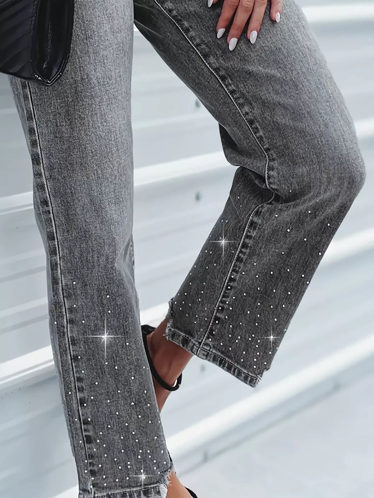 Gray jeans with rhinestone embellishments on a neutral background