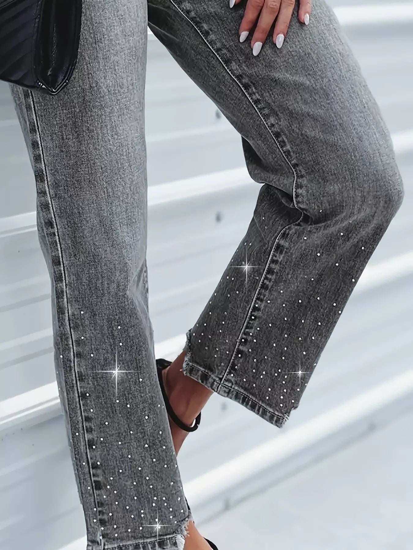 Gray jeans with rhinestone embellishments on a neutral background