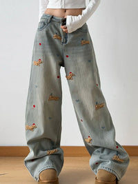 Light blue jeans with embroidered designs on a plain background