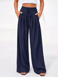 Navy wide-leg pants worn by a person on a white background