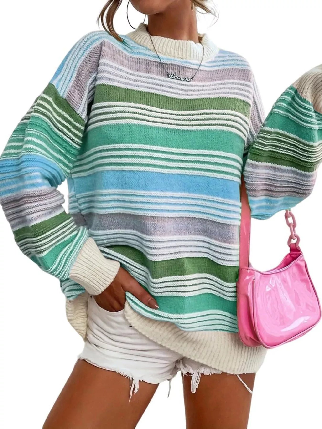 Person wearing a colorful striped sweater with a pink handbag on a white background
