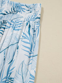 Blue leaf patterned pants on a beige background