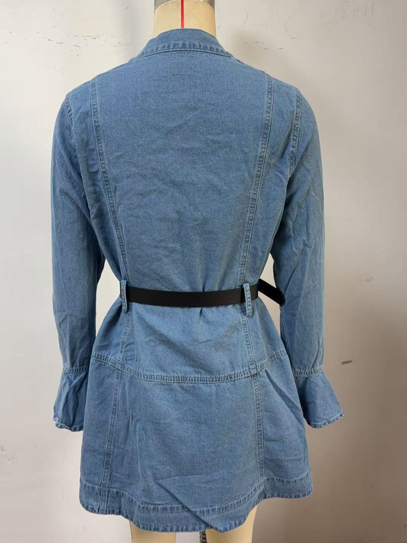 Blue denim dress on a mannequin with a plain background