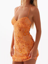 Orange lace dress with floral patterns on a white background