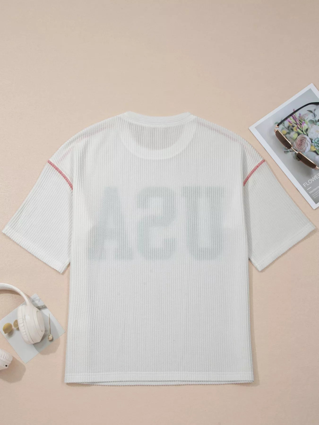 White textured t-shirt on a beige background