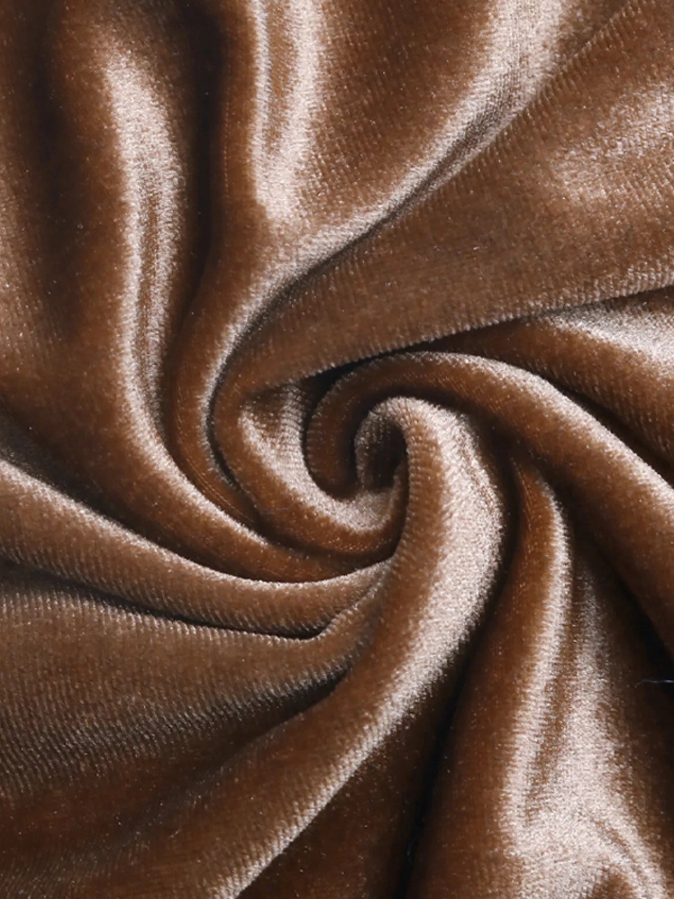 Close-up of brown velvet fabric with a swirl pattern