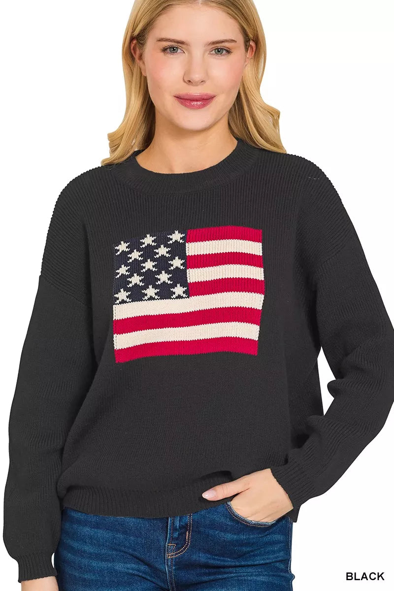 Black sweater with American flag design worn by a model on a white background