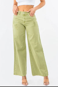 Light green wide-leg jeans worn by a person on a white background