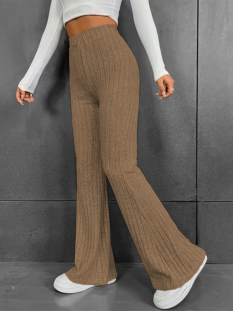 Person wearing brown ribbed wide-leg pants against a gray background