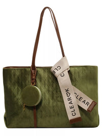 Green tote bag with brown handle and strap, featuring a CLEAR tag.