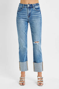 Blue jeans with a distressed hem on a white background