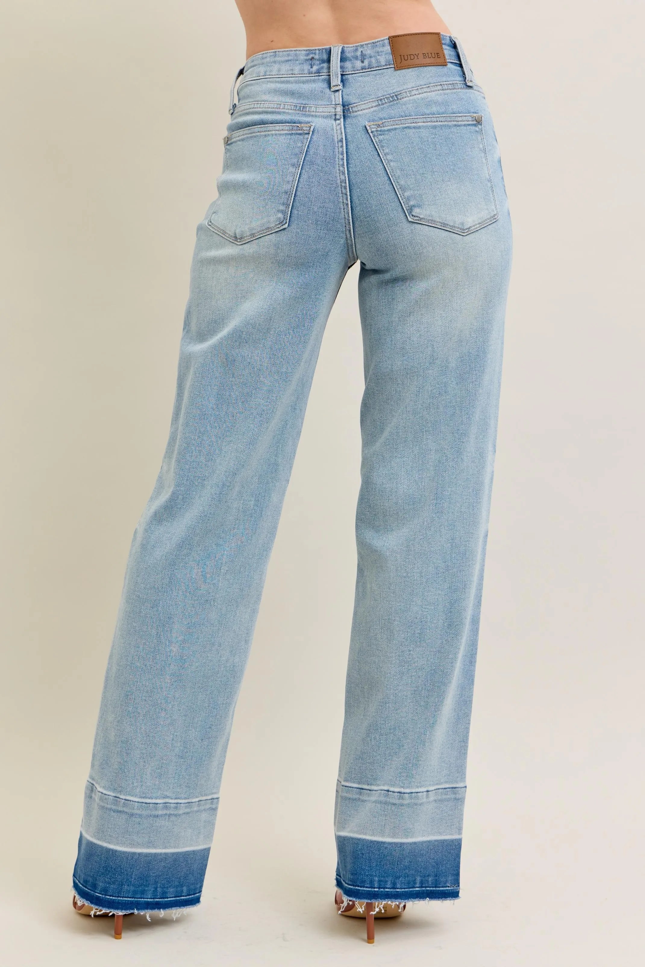 Light blue jeans with a beige background