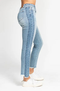 Light blue jeans worn by a person on a white background