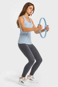 Woman exercising with a resistance ring on a white background