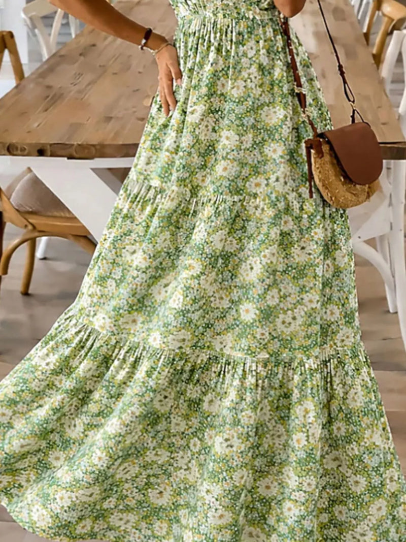 Person wearing a floral dress in an indoor setting with wooden furniture.