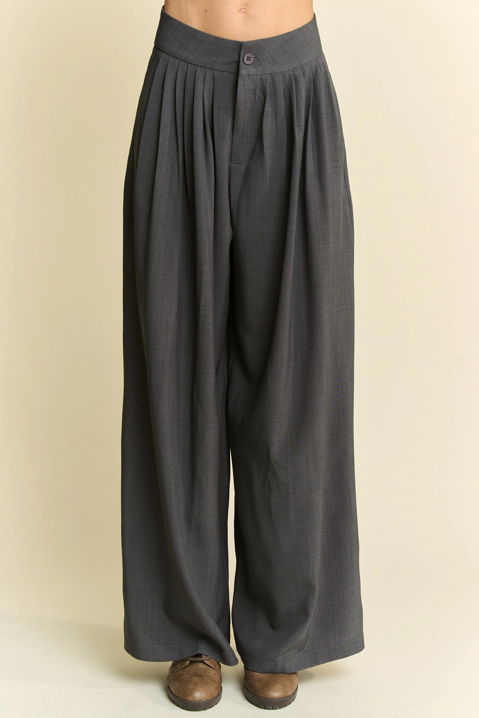 Dark gray wide-leg pants on a beige background