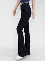 Black flared jeans worn by a person on a white background