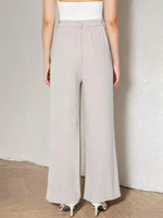 Person wearing light gray wide-leg pants against a plain background