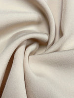 Close-up of beige fabric with folds