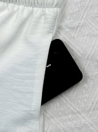 Black smartphone on a textured white surface