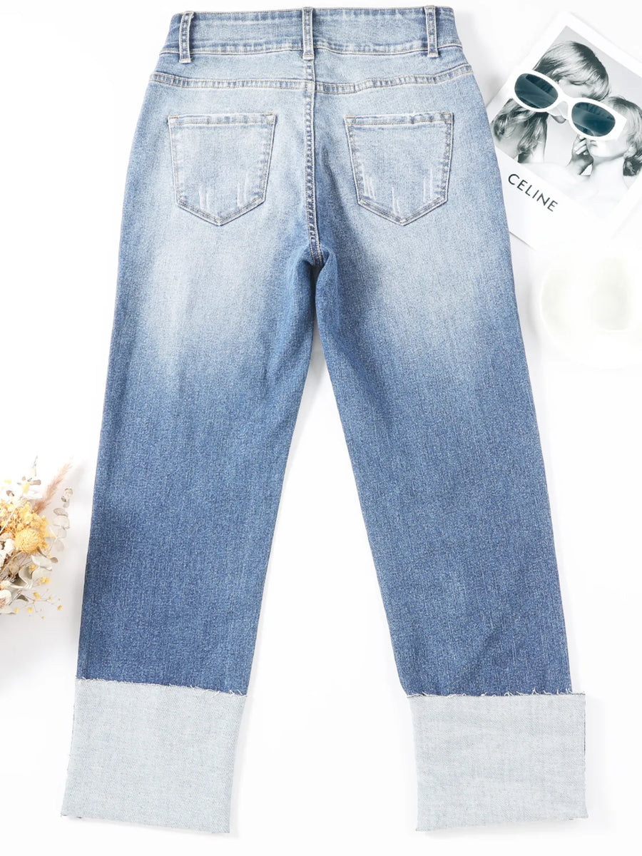 Light blue jeans with white cuffs on a white background
