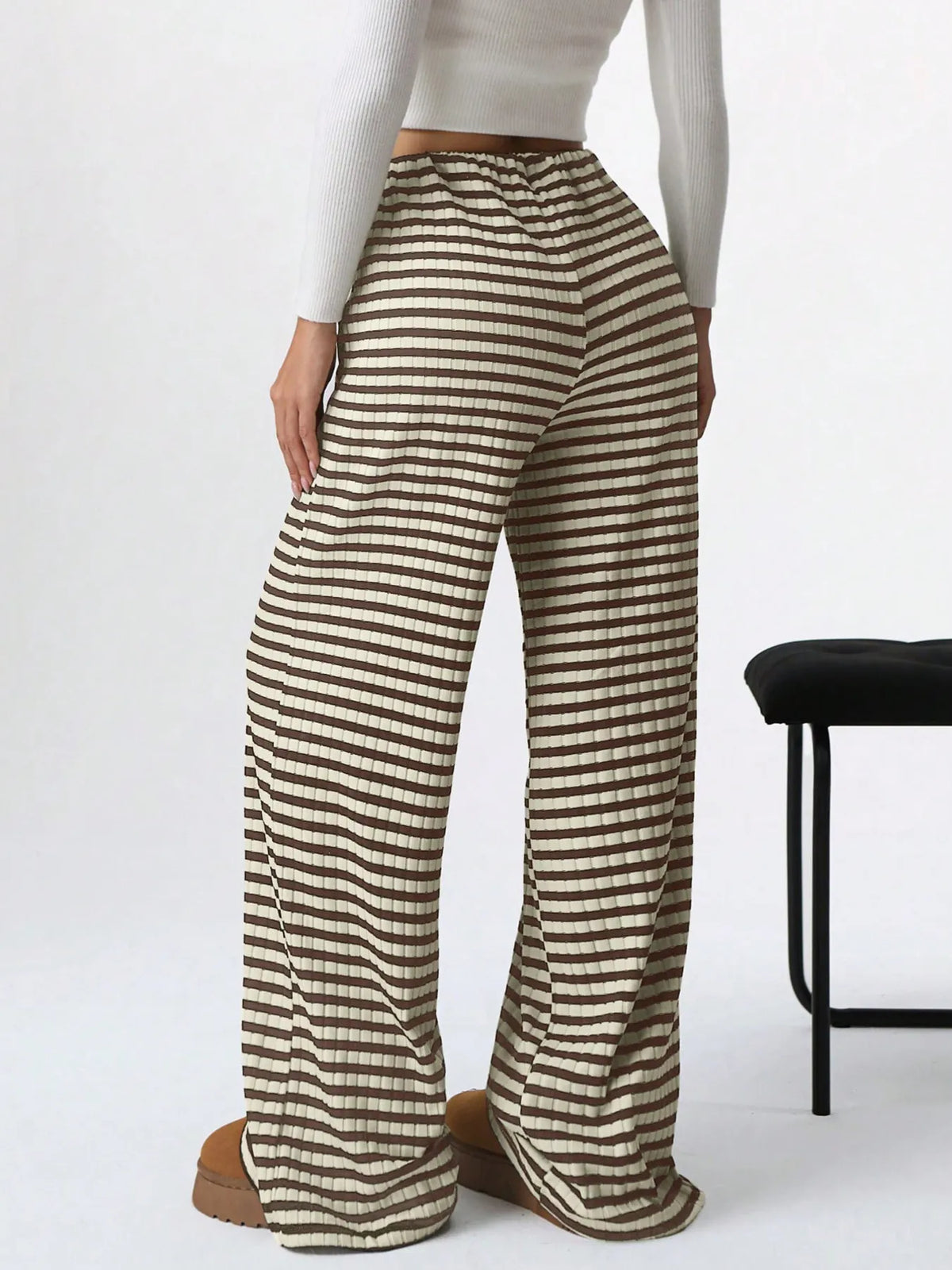 Person wearing striped pants on a white background