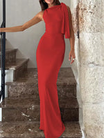Woman in a red dress standing on a marble staircase.