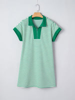 Green and white striped dress on a hanger against a light gray background