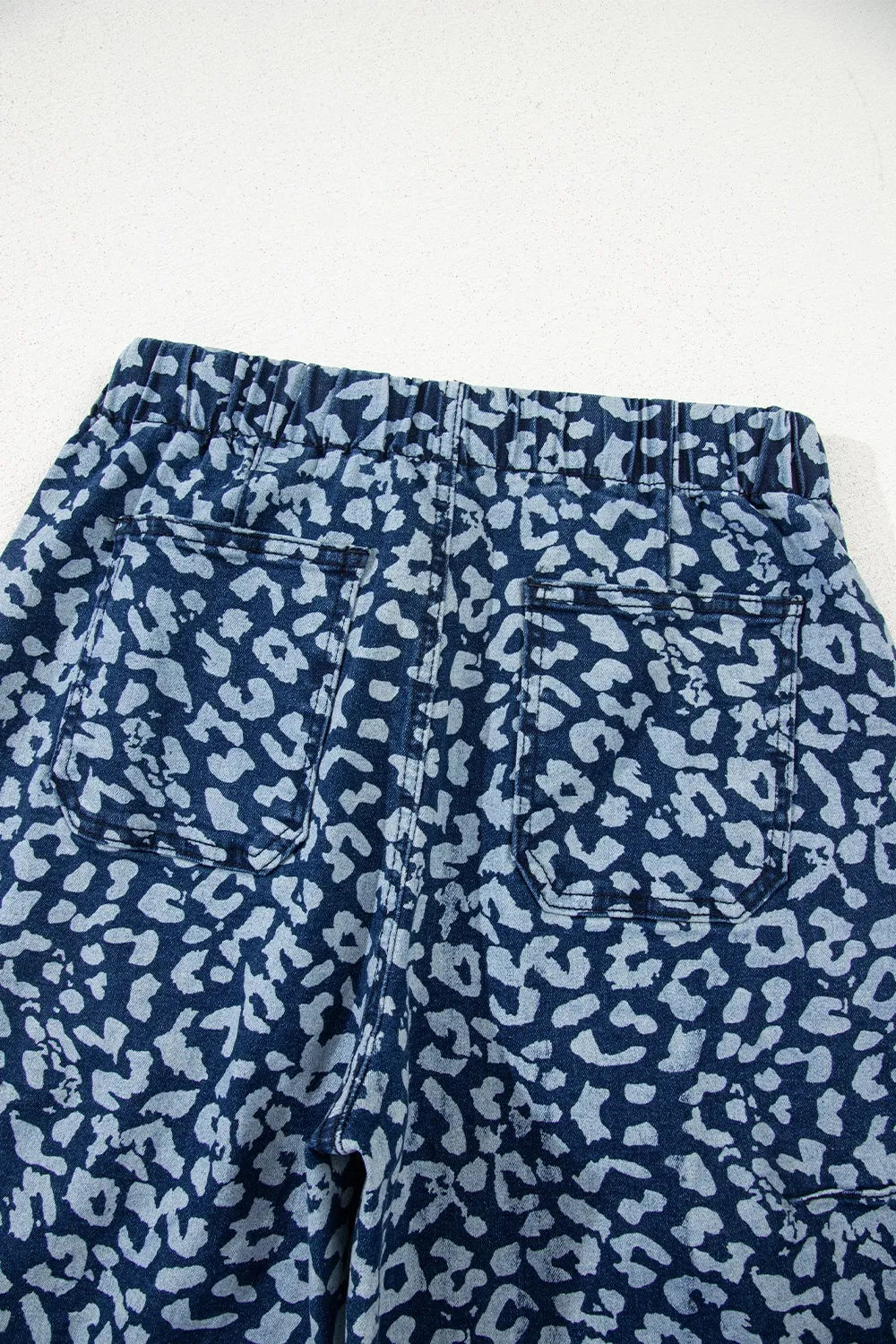 Blue leopard print pants on a white background