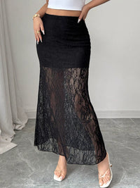 Black lace skirt worn by a person on a neutral background